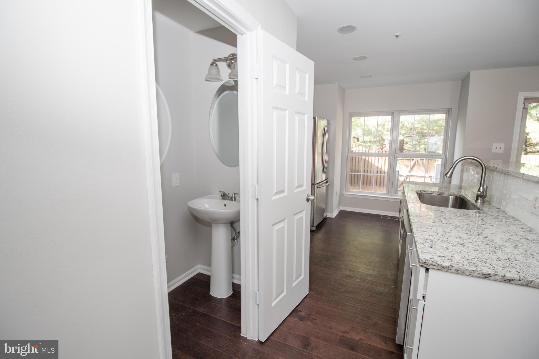 7708 Scatteree Road Severn, MD 21144 - Photo 10 of 41 a bathroom with a granite countertop sink and a mirror