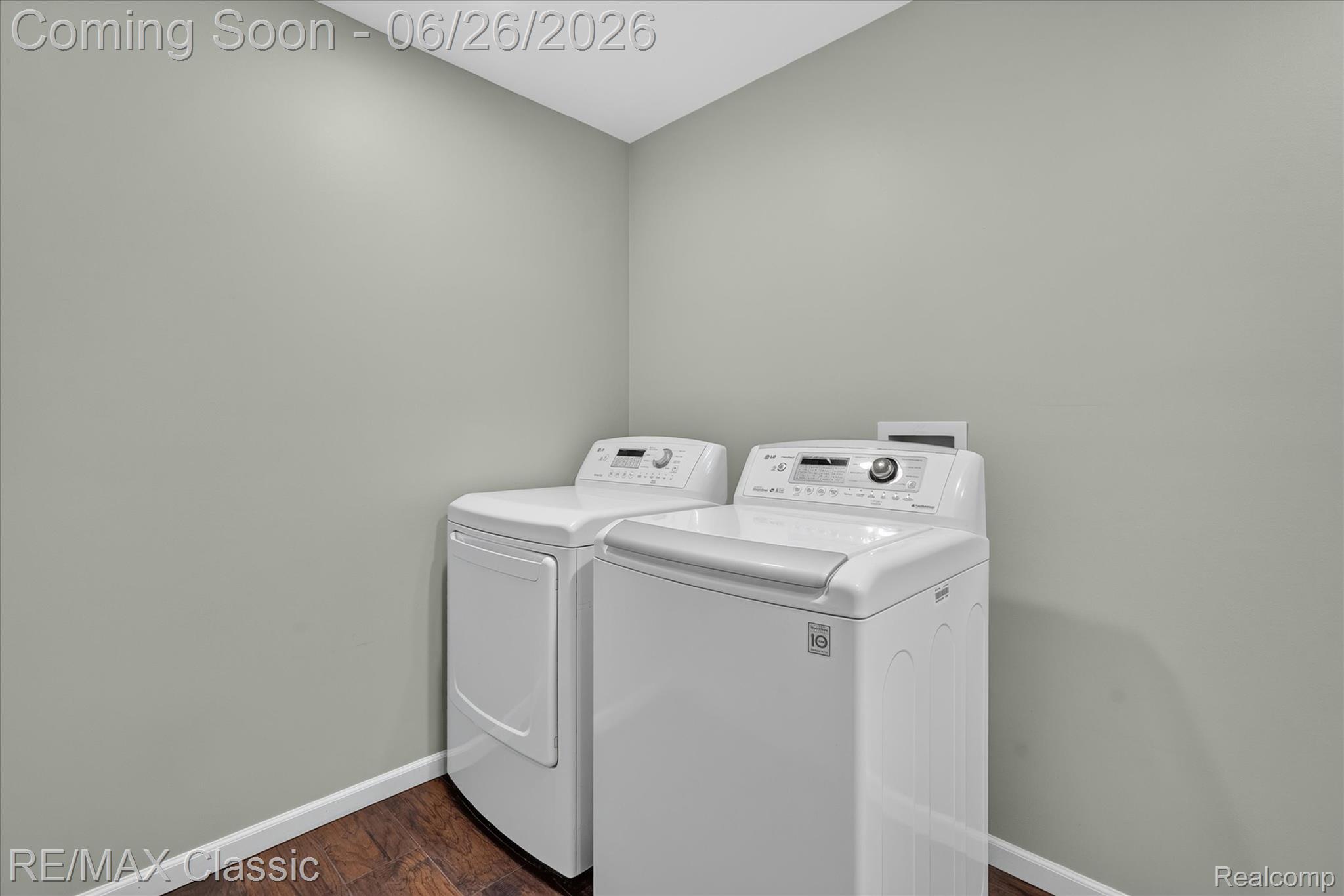 3205 North Milford Road Highland, MI 48357 - Photo 32 of 53 Dedicated laundry area featuring wood-finish flooring, light neutral-toned walls, and white baseboards