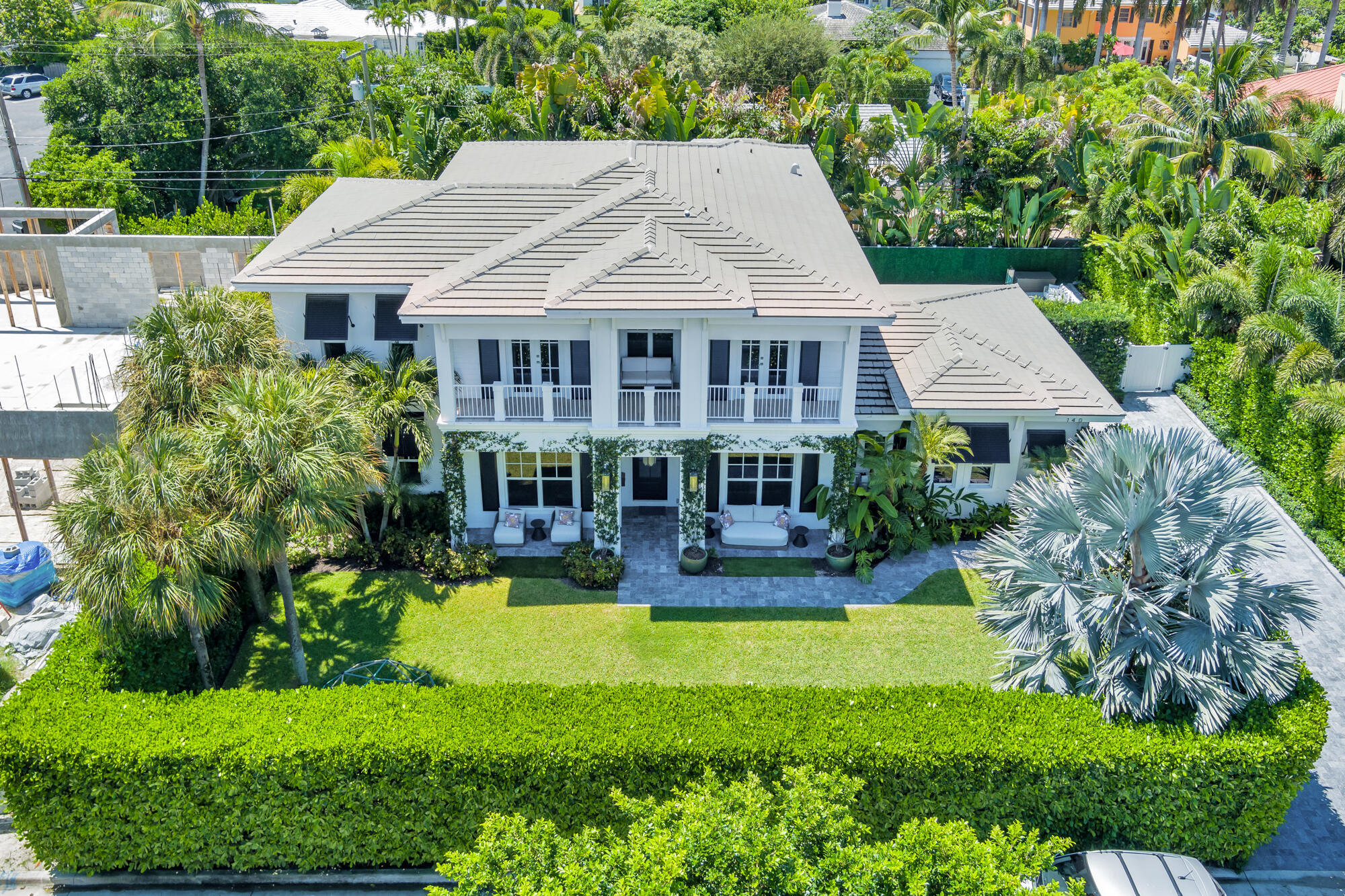 a front view of a house with swimming pool having outdoor seating