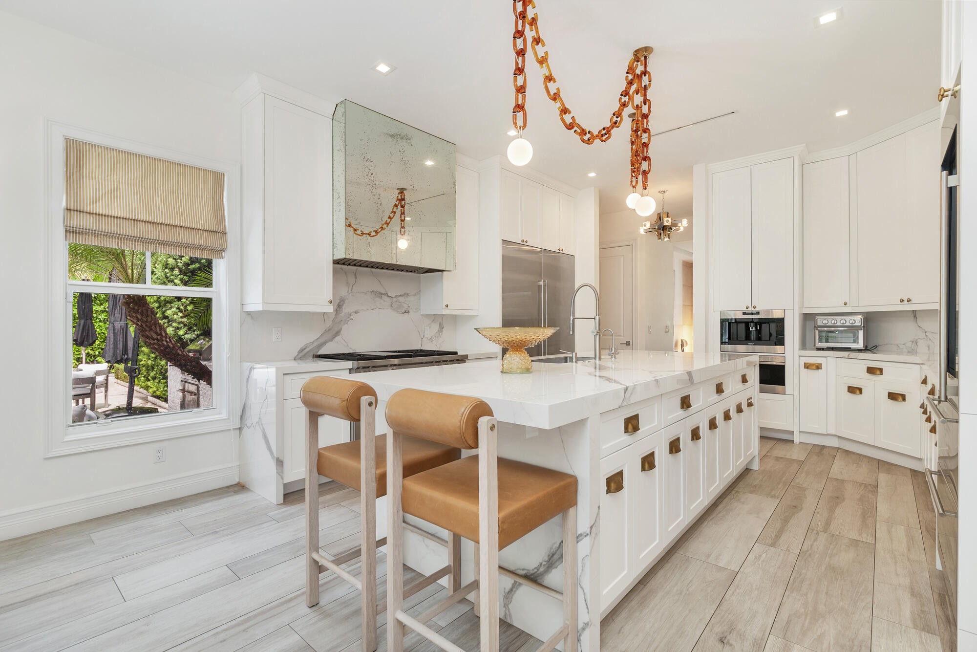 140 Edmor Road West Palm Beach, FL 33405 - Photo 6 of 30 a kitchen with stainless steel appliances granite countertop a stove a sink dishwasher and a dining table with wooden floor