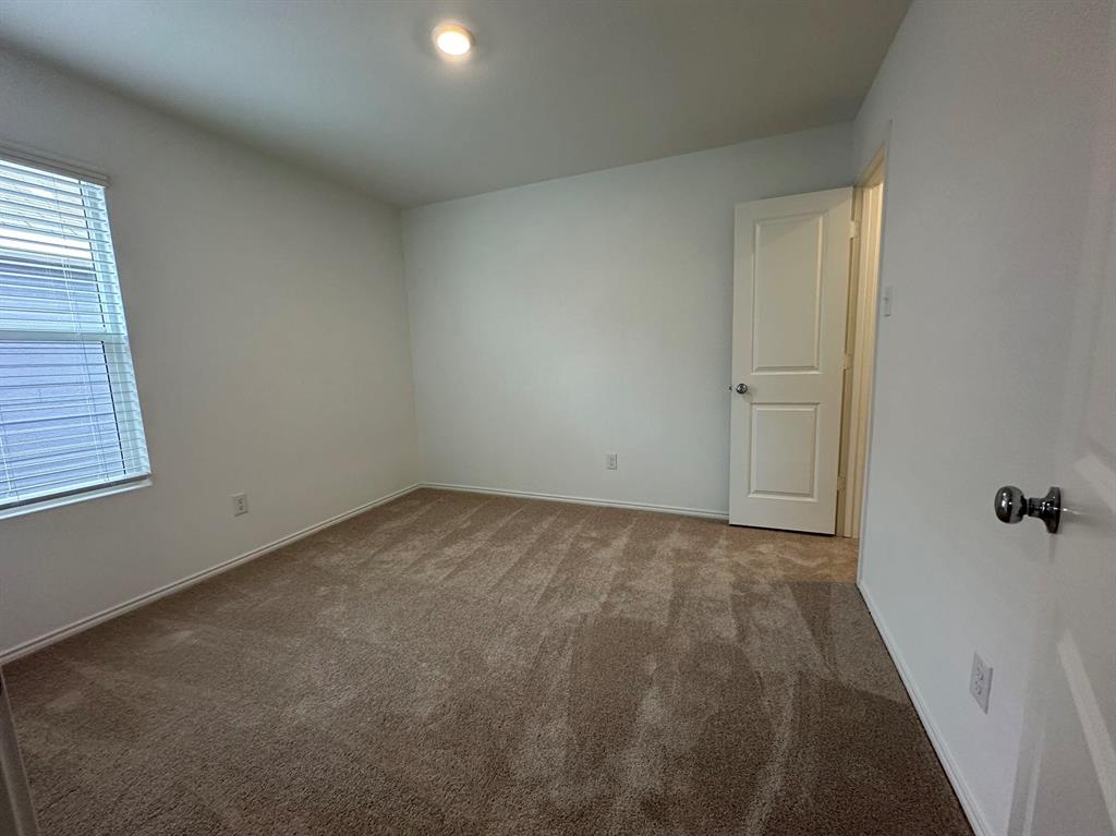 320 Dewberry Street Princeton, TX 75407 - Photo 11 of 19 an empty room with a empty space and windows