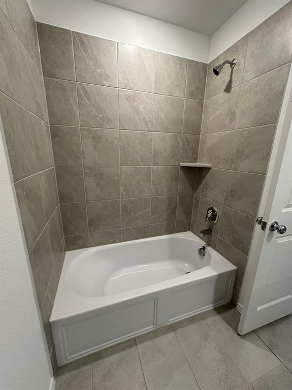 320 Dewberry Street Princeton, TX 75407 - Photo 14 of 19 a white bath tub sitting in a bathroom