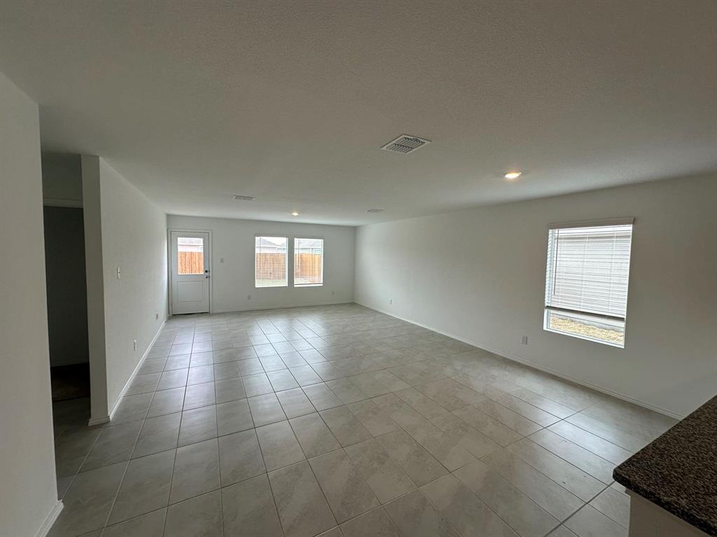 320 Dewberry Street Princeton, TX 75407 - Photo 4 of 19 a view of empty room with windows