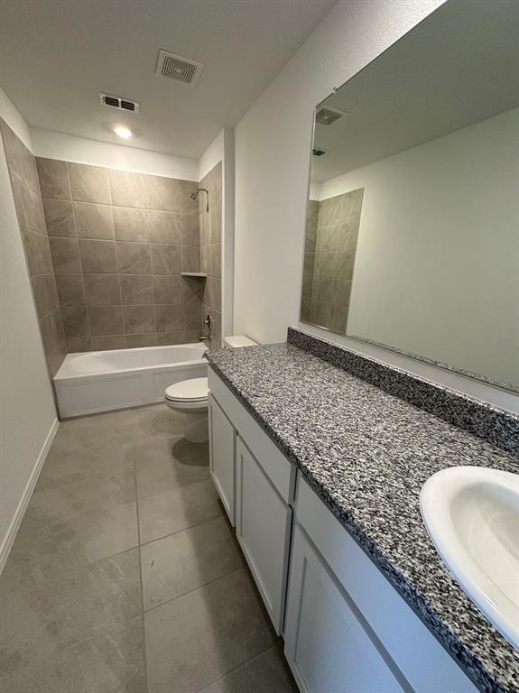 320 Dewberry Street Princeton, TX 75407 - Photo 5 of 19 a bathroom with a granite countertop sink a toilet and shower
