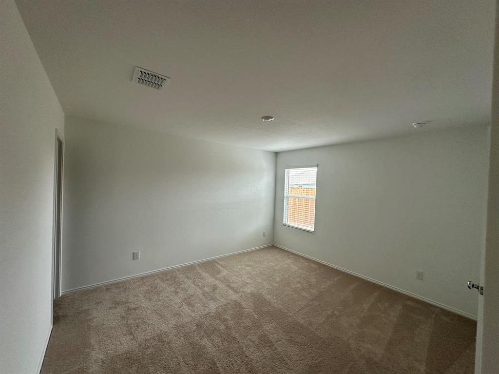 320 Dewberry Street Princeton, TX 75407 - Photo 7 of 19 an empty room with a window