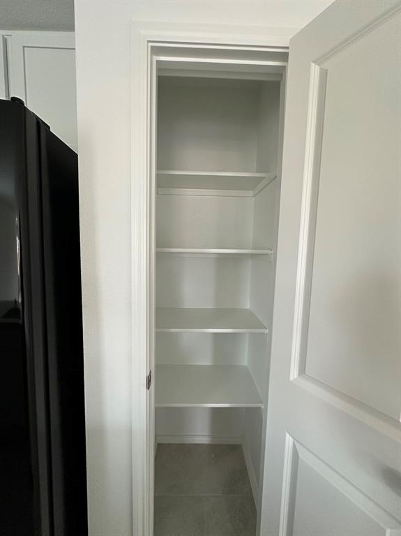 320 Dewberry Street Princeton, TX 75407 - Photo 9 of 19 a view of walk in closet with empty racks