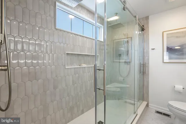 a bathroom with a shower and toilet