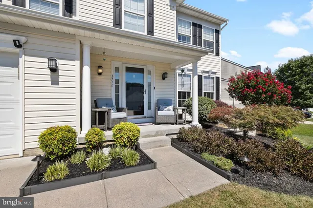 a view of a house with potted plants