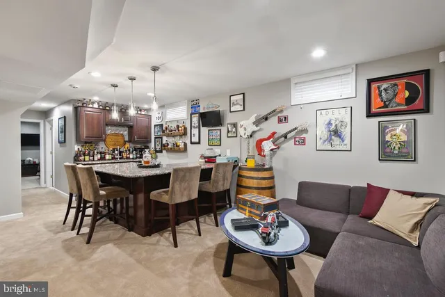 a living room with lots of furniture and kitchen view