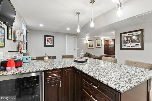 a kitchen with granite countertop a sink and a wooden floor
