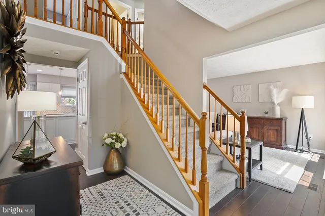a view of entryway and hall with wooden floor