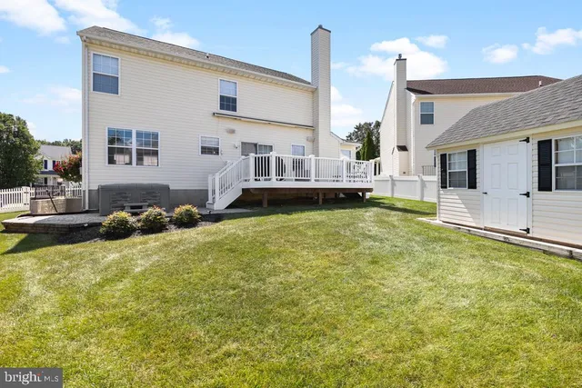 a view of a house with a big yard and large trees