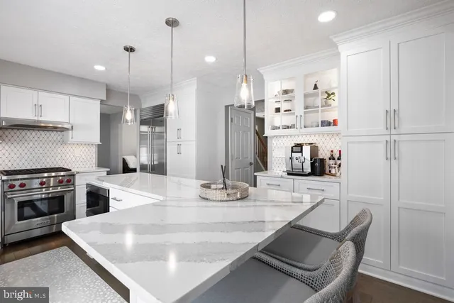 a kitchen with stainless steel appliances granite countertop a sink a stove and a refrigerator