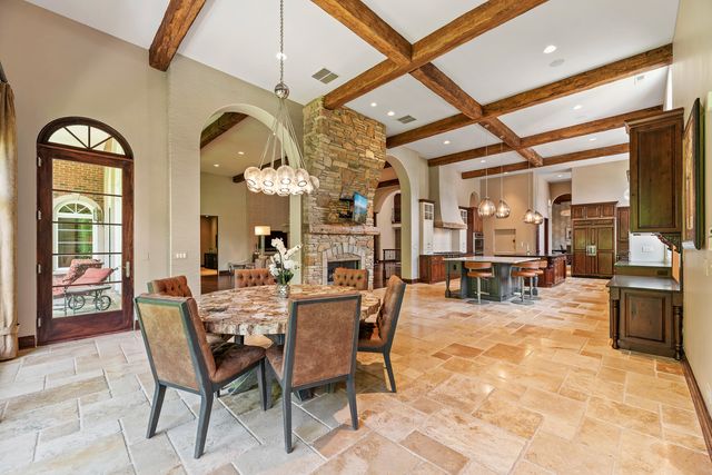 a view of a dining room with furniture and a chandelier