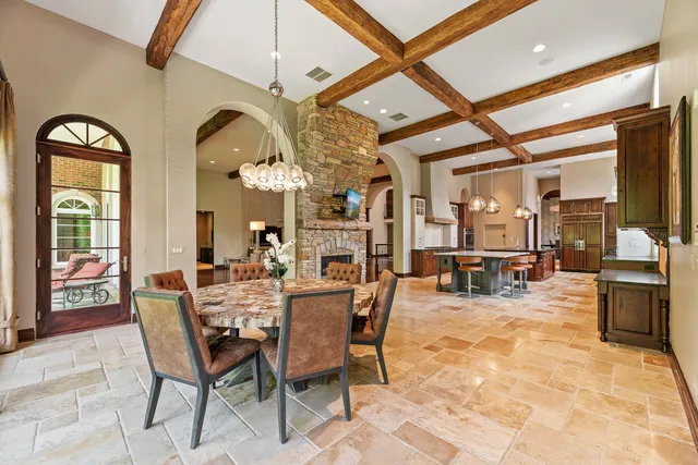 a view of a dining room with furniture and a chandelier