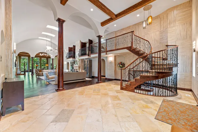 a living room with fireplace furniture and a chandelier