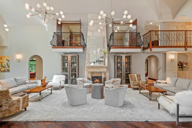 a living room with fireplace furniture and a wooden floor