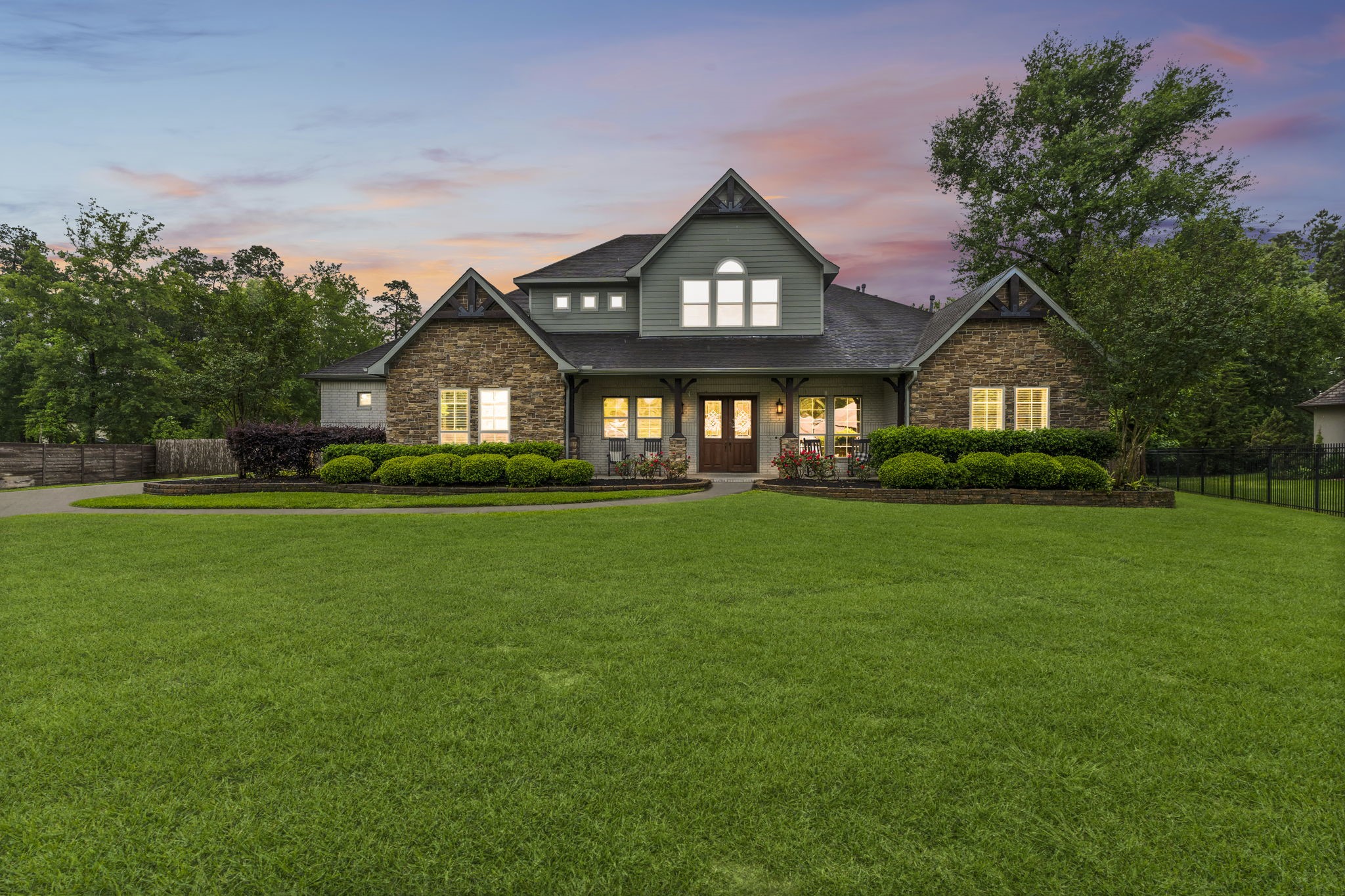 a front view of a house with a garden