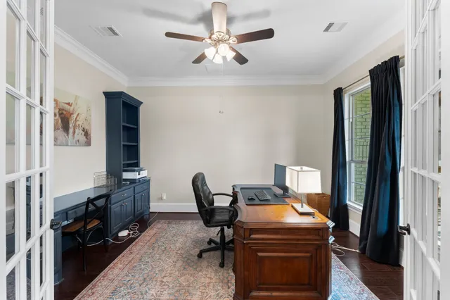 a view of a workspace with furniture and a window