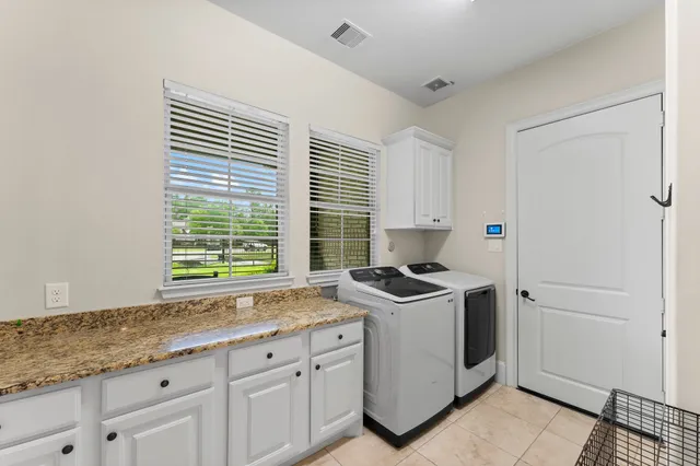 a kitchen with granite countertop a sink stove and cabinets