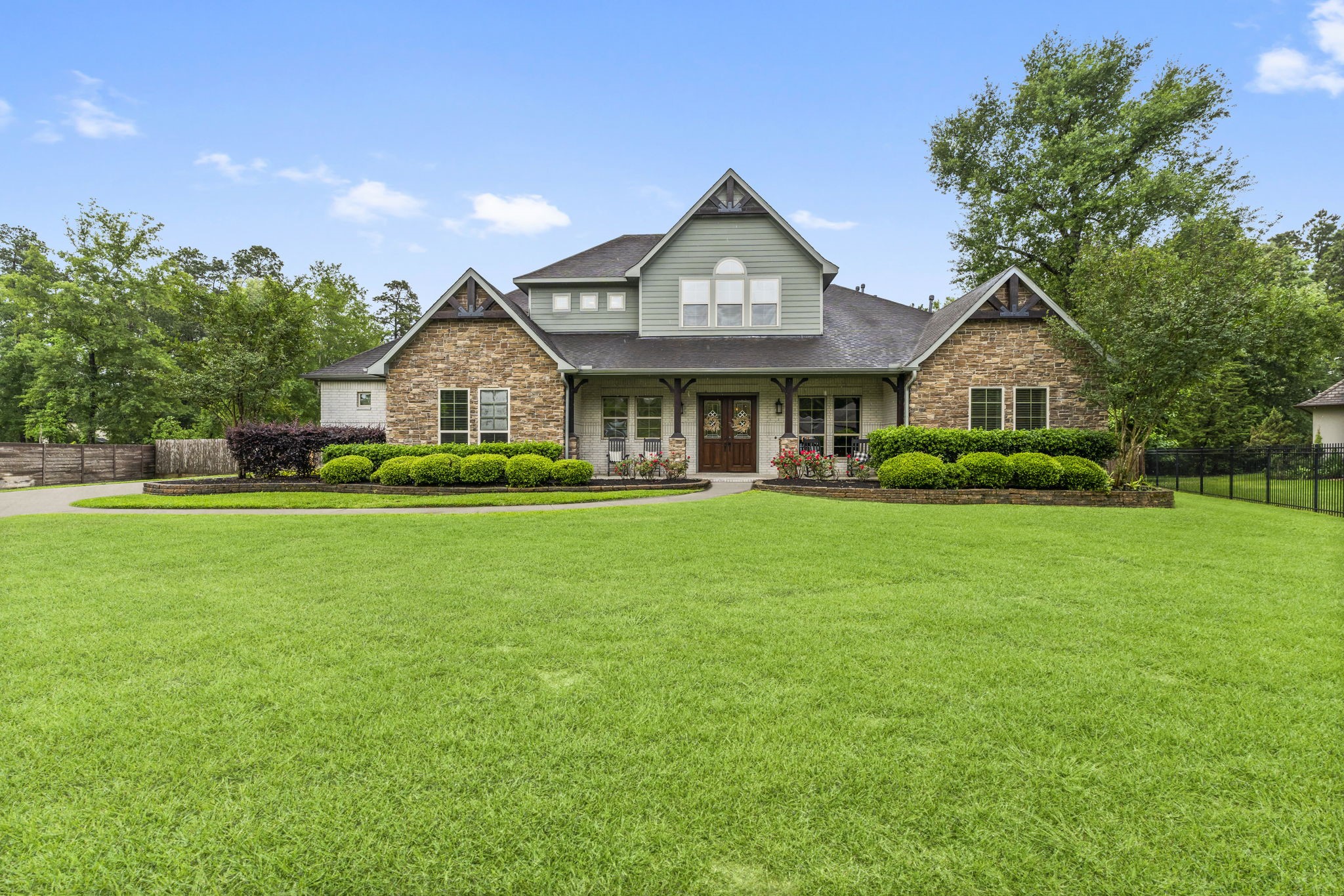 5006 Newport Court Spring, TX 77386 - Photo 2 of 46 a front view of a house with a garden and trees