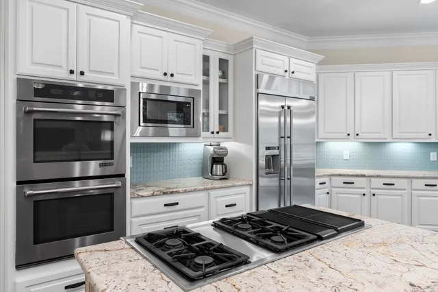 a kitchen with granite countertop cabinets and steel stainless steel appliances