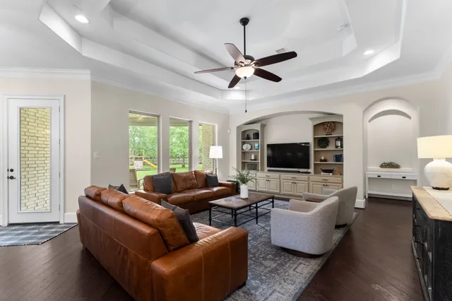 a living room with furniture fireplace and a flat screen tv