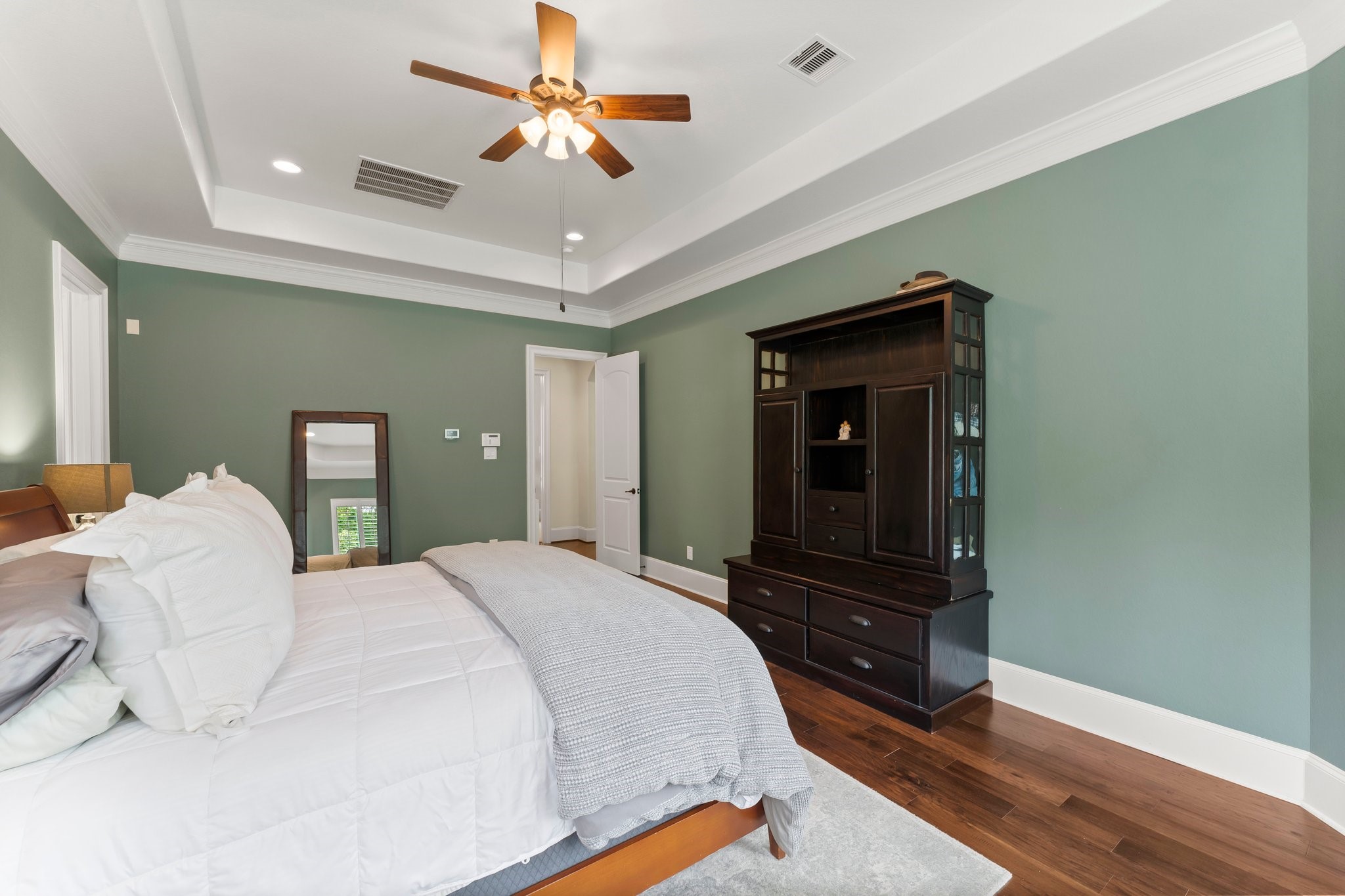 5006 Newport Court Spring, TX 77386 - Photo 32 of 46 a bedroom with a bed and a chandelier