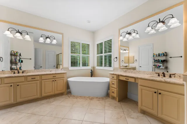 a spacious bathroom with a granite countertop sink and a mirror