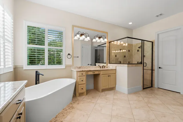 a large bathroom with a large tub and sink