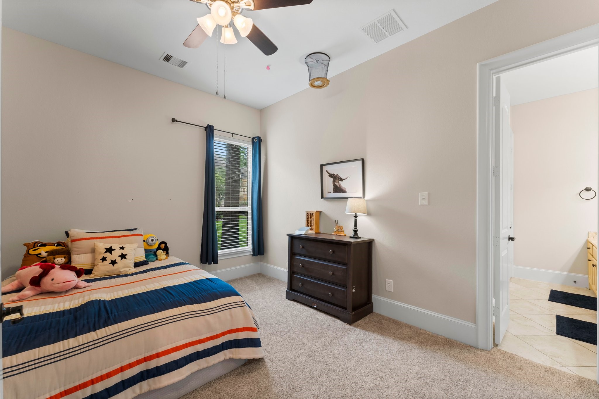 5006 Newport Court Spring, TX 77386 - Photo 35 of 46 a bedroom with a bed and a chandelier