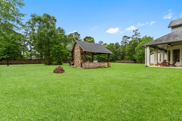 a view of a house with a backyard and a patio