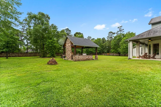 a view of a house with a backyard porch and sitting area