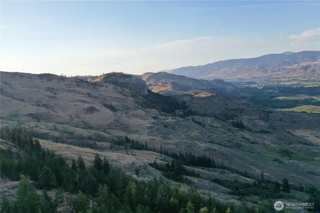 a view of a lush green hillside and a building