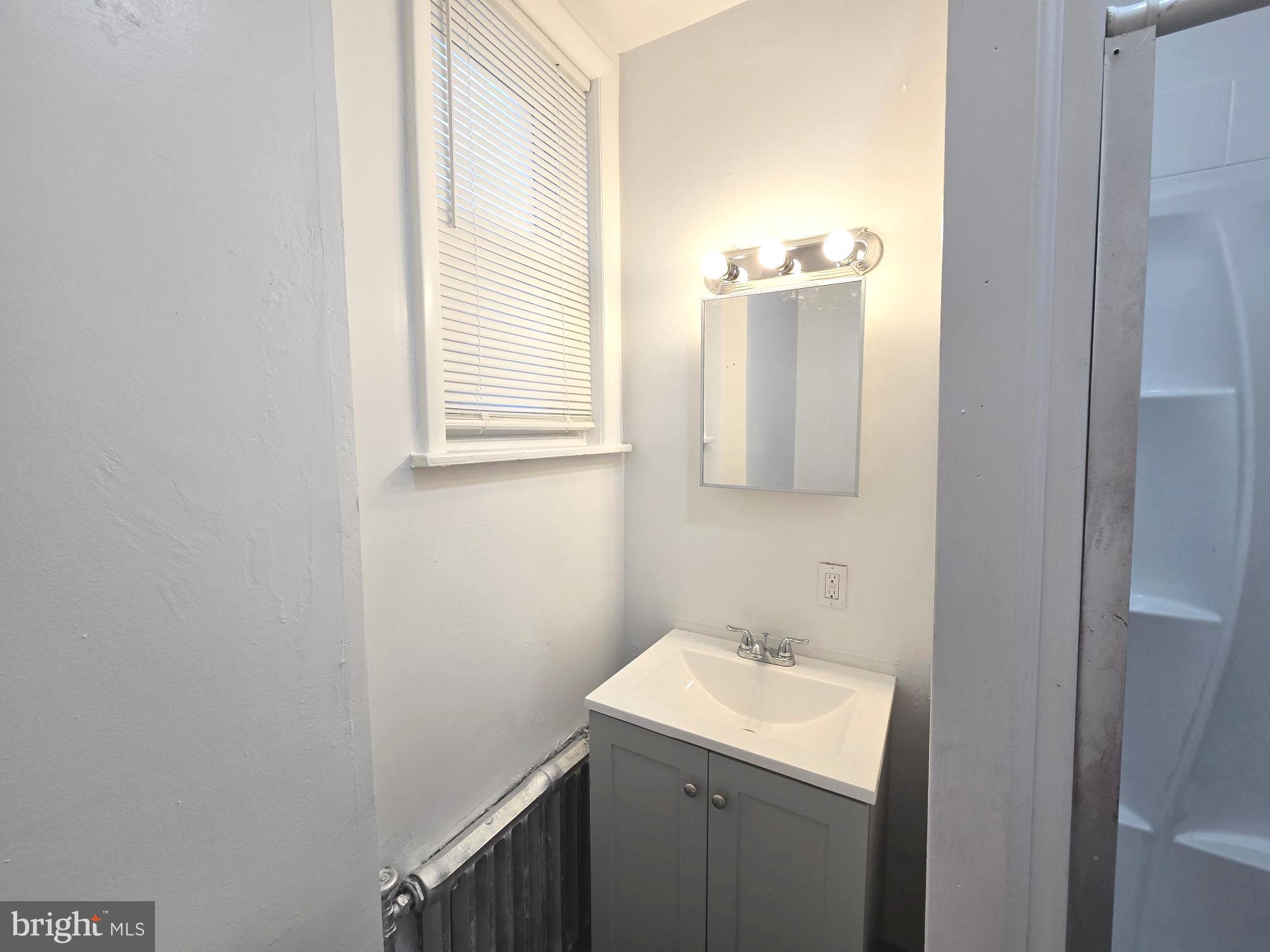 5140 North Fairhill Street Philadelphia, PA 19120 - Photo 14 of 24 a bathroom with a sink and a mirror