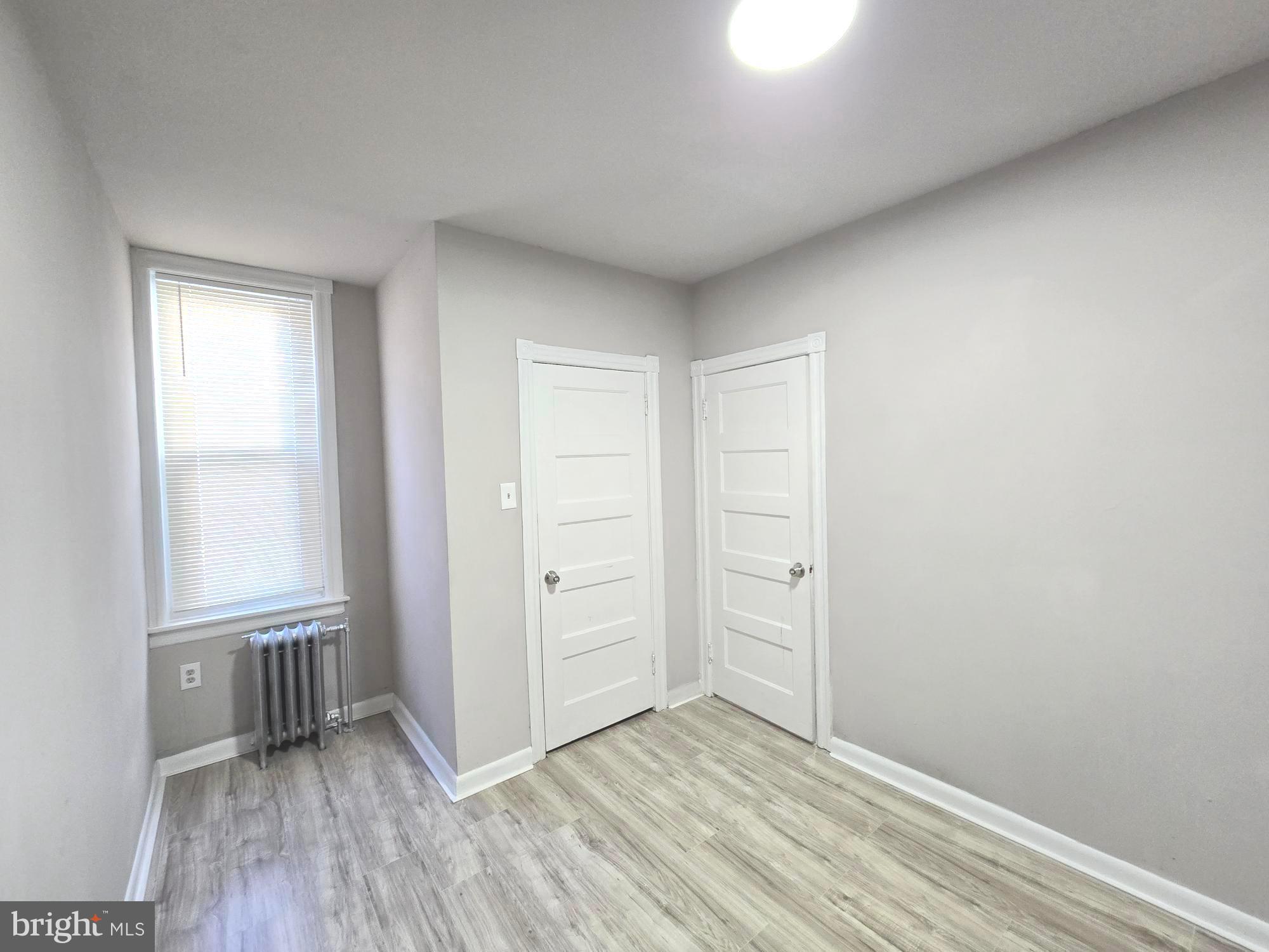 5140 North Fairhill Street Philadelphia, PA 19120 - Photo 18 of 24 an empty room with wooden floor and windows