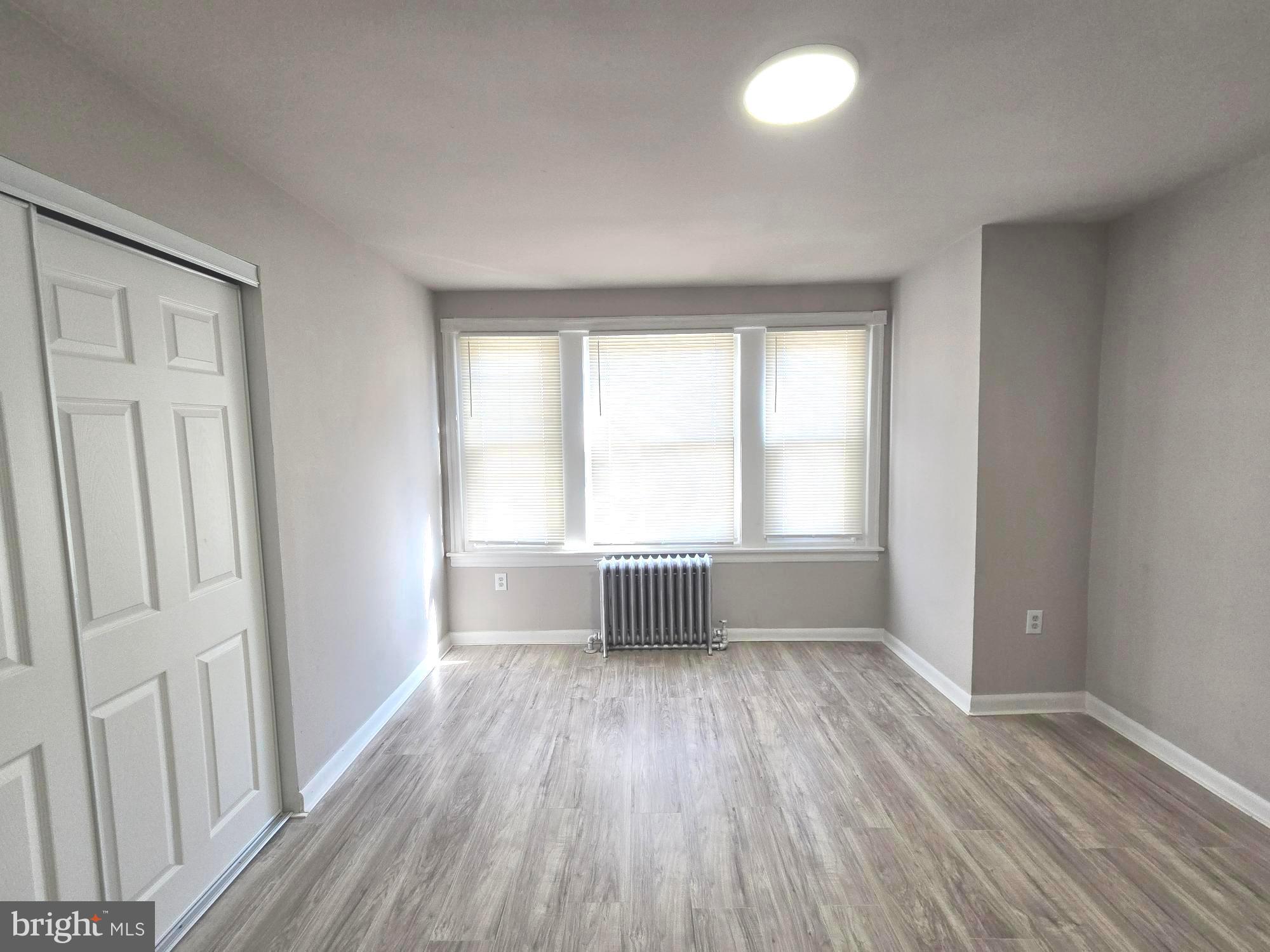 5140 North Fairhill Street Philadelphia, PA 19120 - Photo 20 of 24 an empty room with wooden floor and windows