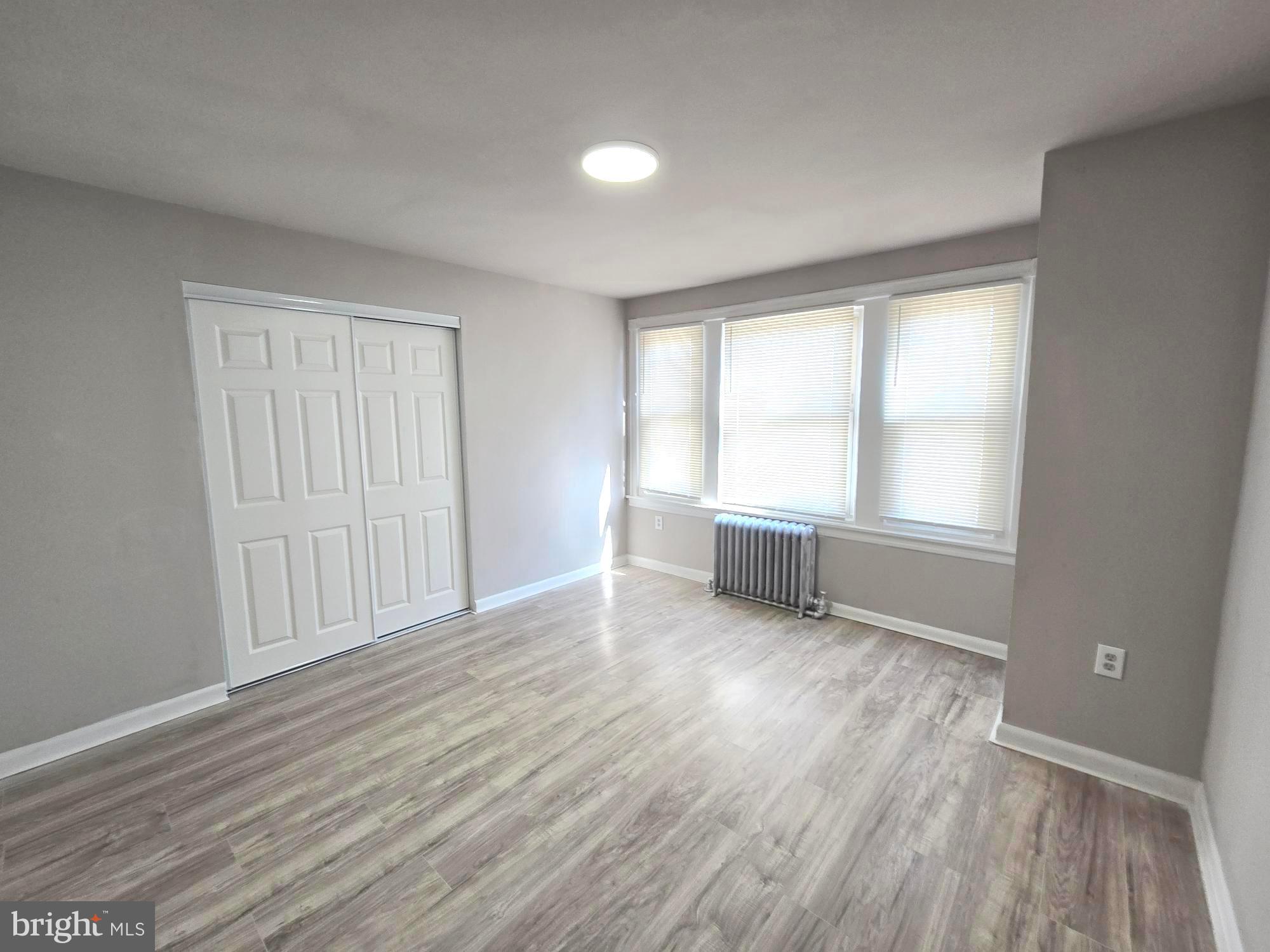 5140 North Fairhill Street Philadelphia, PA 19120 - Photo 21 of 24 an empty room with wooden floor and windows