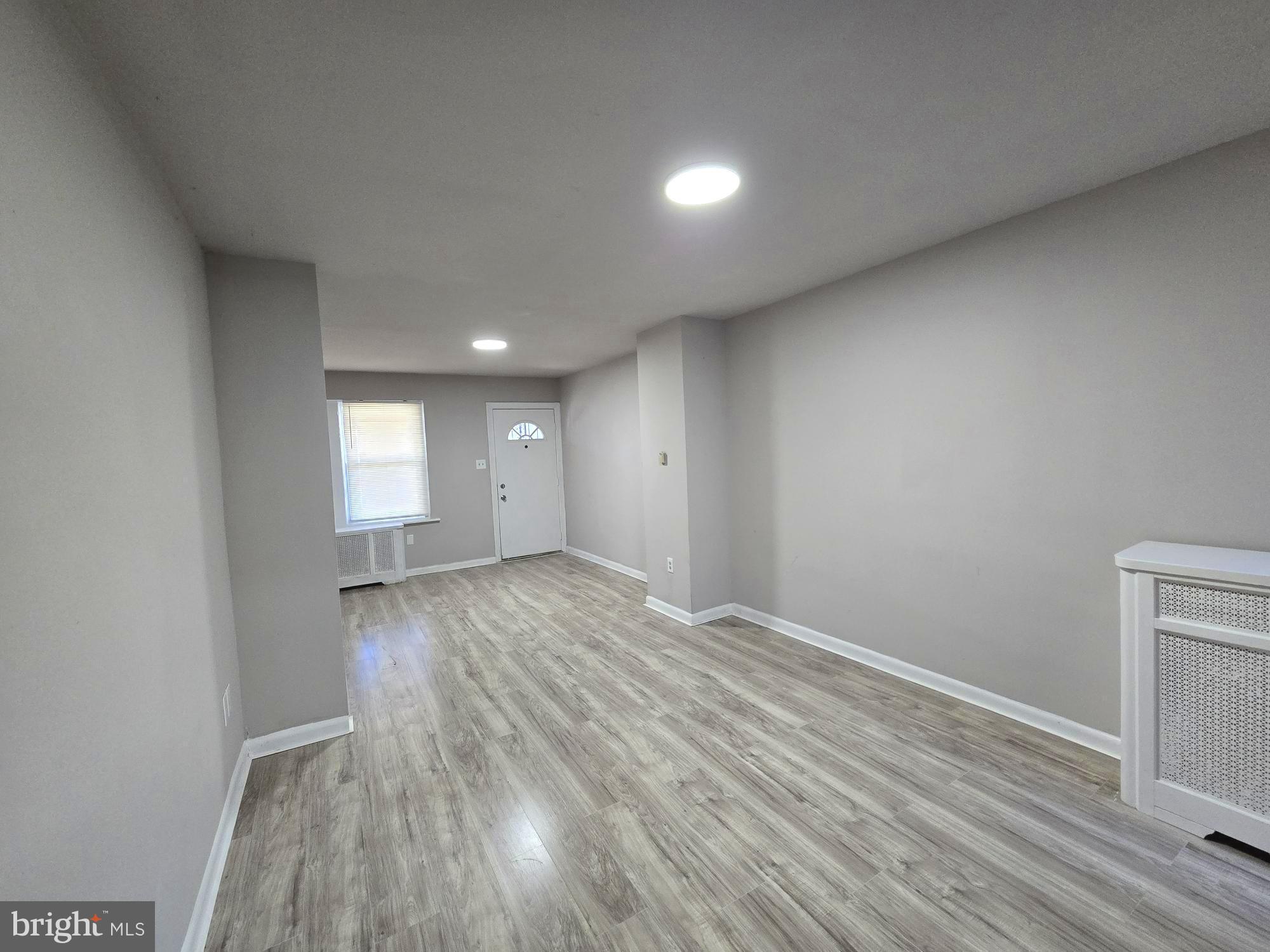 5140 North Fairhill Street Philadelphia, PA 19120 - Photo 4 of 24 a view of empty room with wooden floor and fan