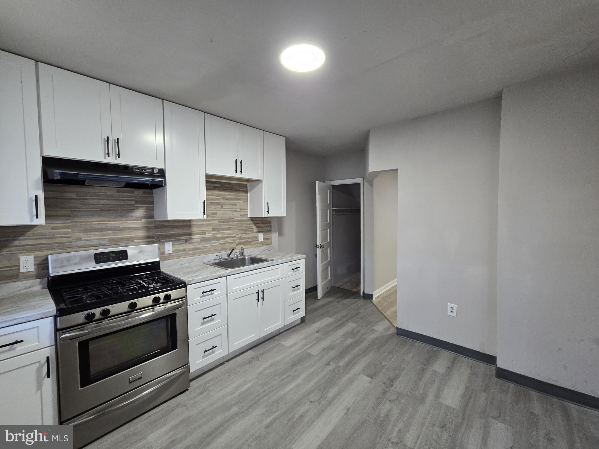 5140 North Fairhill Street Philadelphia, PA 19120 - Photo 5 of 24 a kitchen with granite countertop a stove and a sink