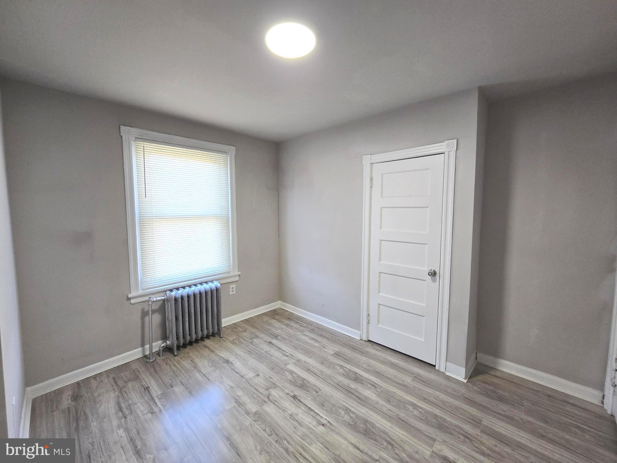 5140 North Fairhill Street Philadelphia, PA 19120 - Photo 10 of 24 an empty room with wooden floor and windows