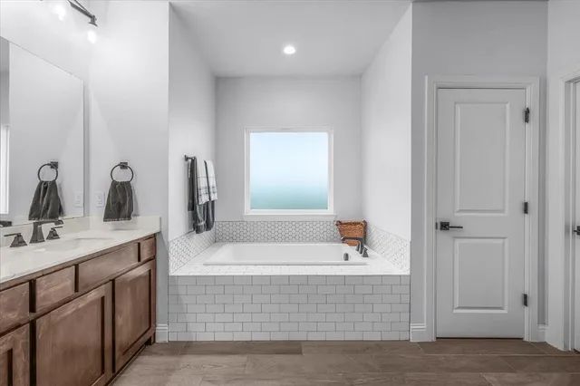 a spacious bathroom with a double vanity sink a mirror and shower