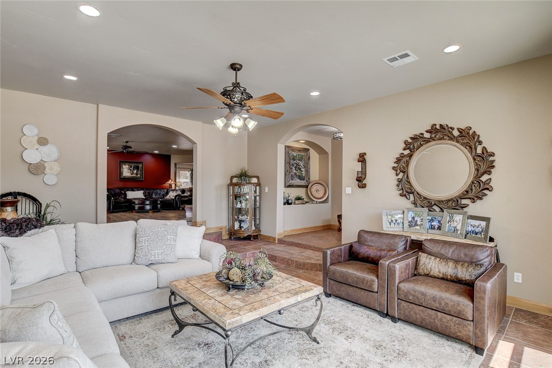 1950 Bowman Road Logandale, NV 89021 - Photo 9 of 81 Archways and a ceiling fan define this inviting living space, connecting seamlessly to additional rooms.