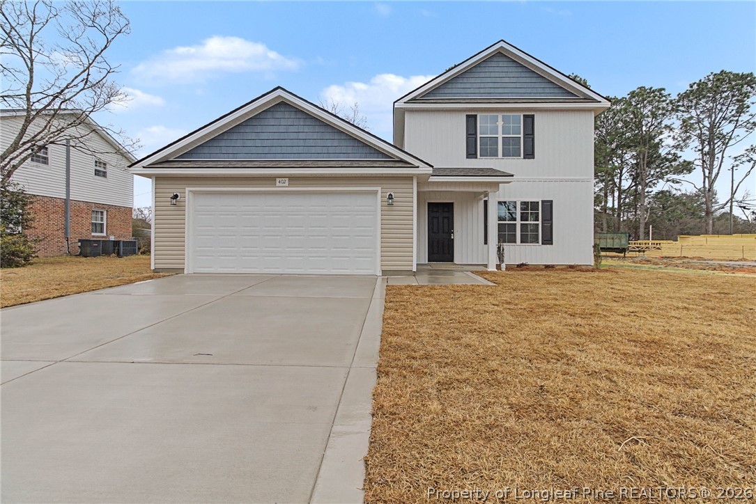 402 Rutherford Street Spring Lake, NC 28390 - Photo 1 of 34 a front view of a house with a yard and garage