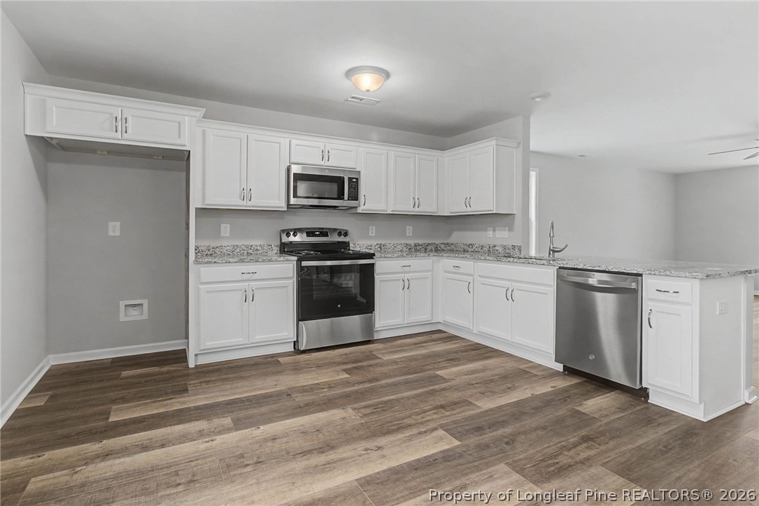 402 Rutherford Street Spring Lake, NC 28390 - Photo 12 of 34 a kitchen with white cabinets stainless steel appliances and sink