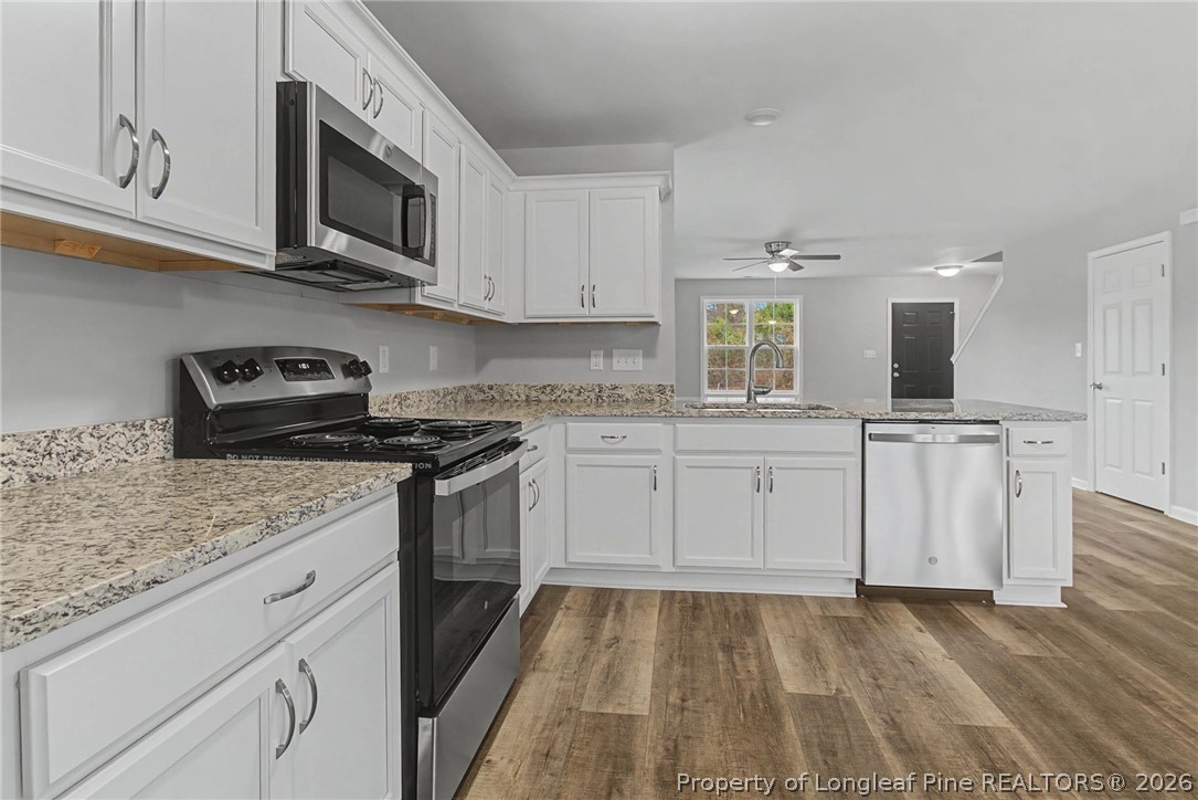 402 Rutherford Street Spring Lake, NC 28390 - Photo 13 of 34 a kitchen with granite countertop a sink and cabinets