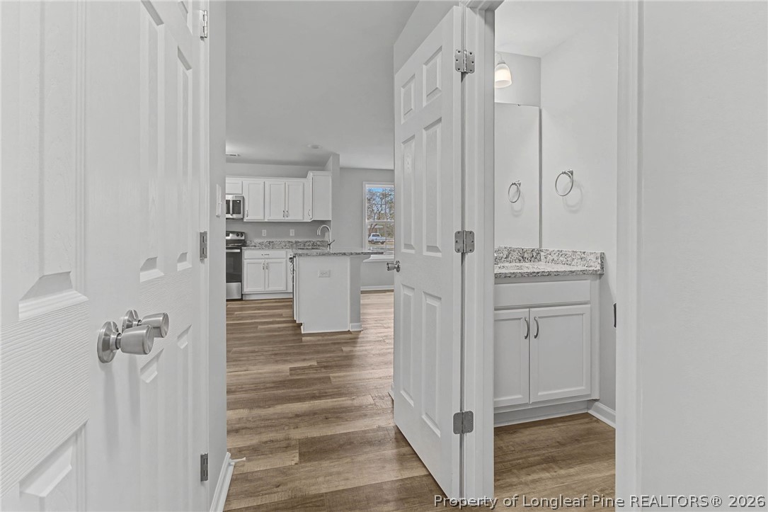 402 Rutherford Street Spring Lake, NC 28390 - Photo 16 of 34 a view of a kitchen with white cabinets and stainless steel appliances