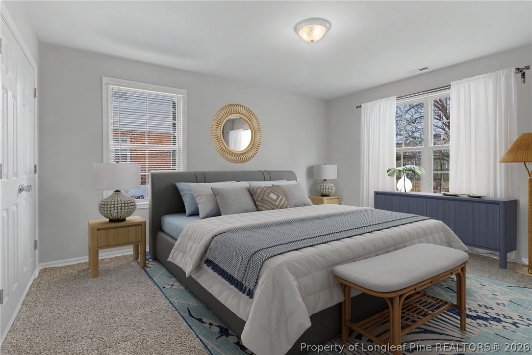 402 Rutherford Street Spring Lake, NC 28390 - Photo 17 of 34 a bedroom with a bed and a window