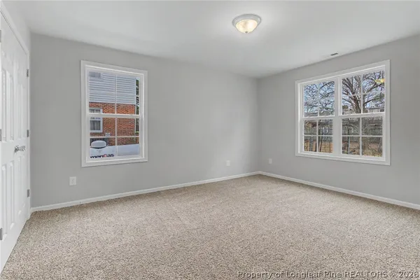a view of an empty room and closet area