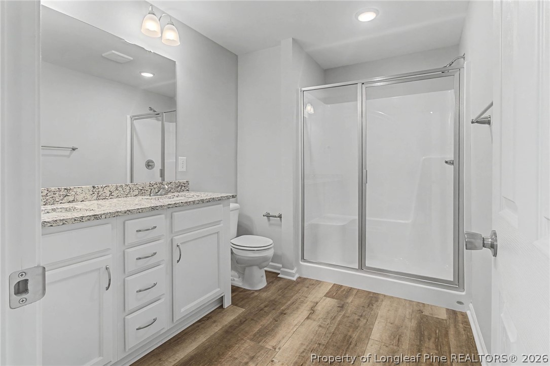 402 Rutherford Street Spring Lake, NC 28390 - Photo 20 of 34 a bathroom with a granite countertop sink toilet and shower